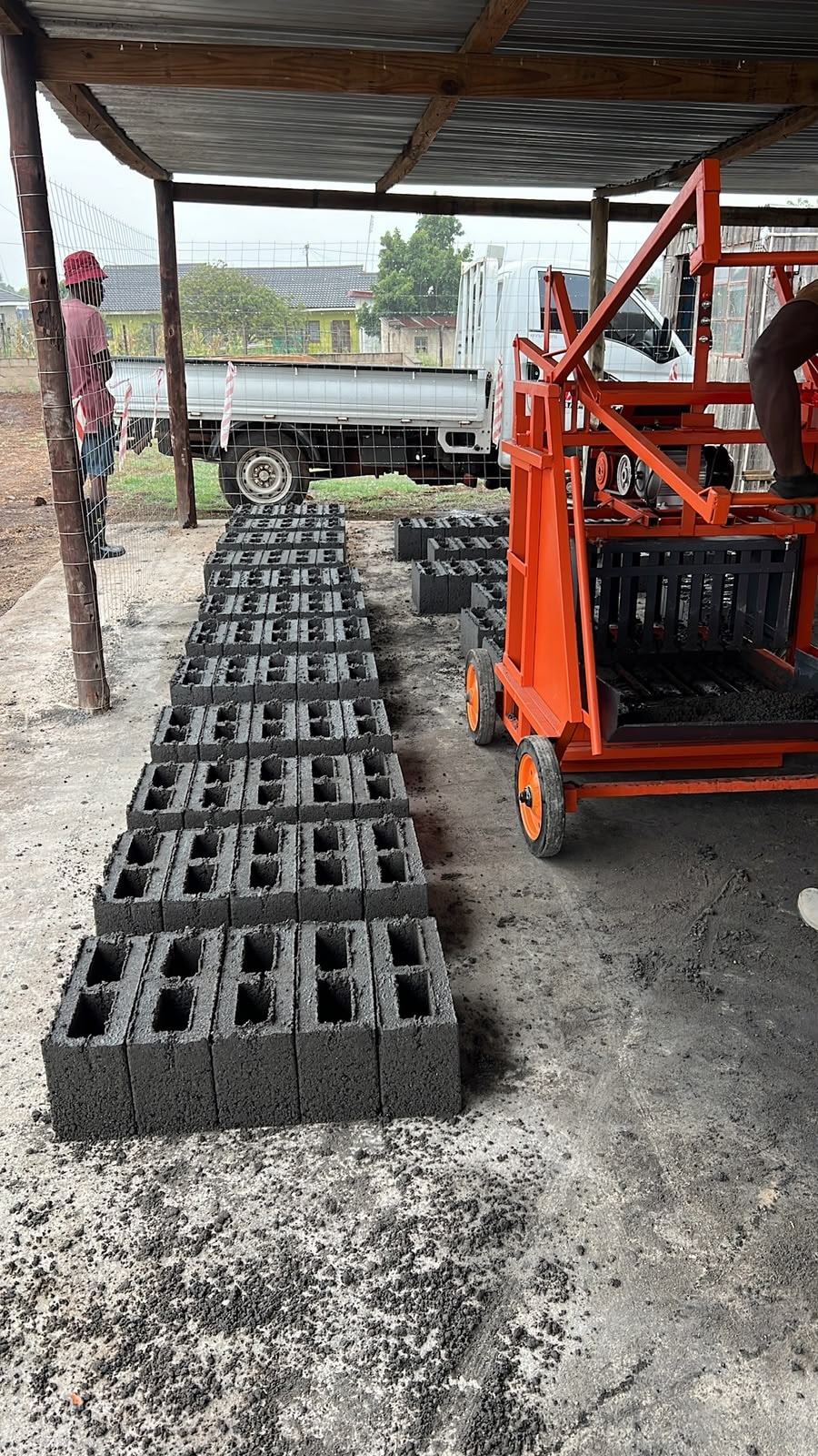 Fresh concrete building blocks being produced by Masinga block machine